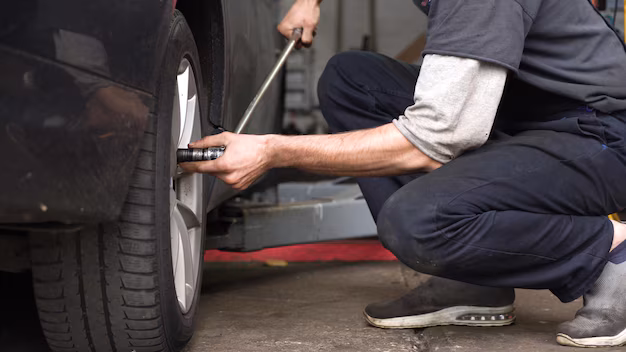 Mechanic adjusting the tire on the car