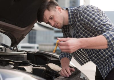 Mechanic checking fuel injector efficiency